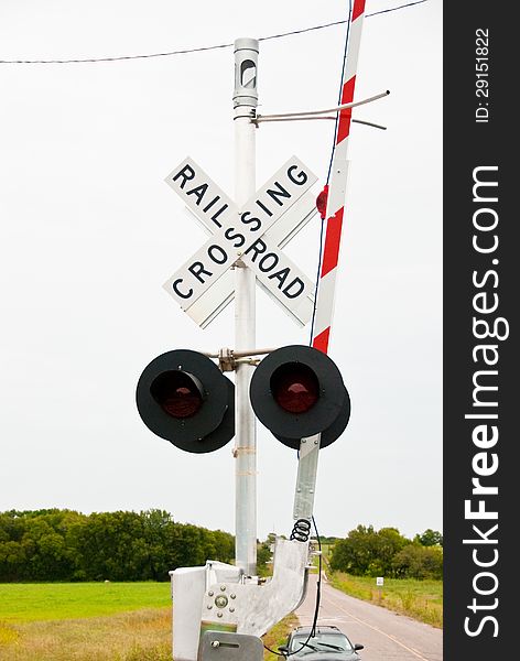 Railroad crossing sign on a country road with gate up. Railroad crossing sign on a country road with gate up.