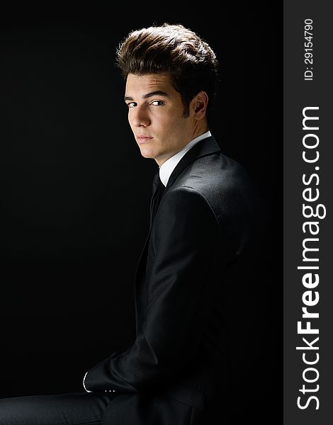 Young businessman, isolated on black background