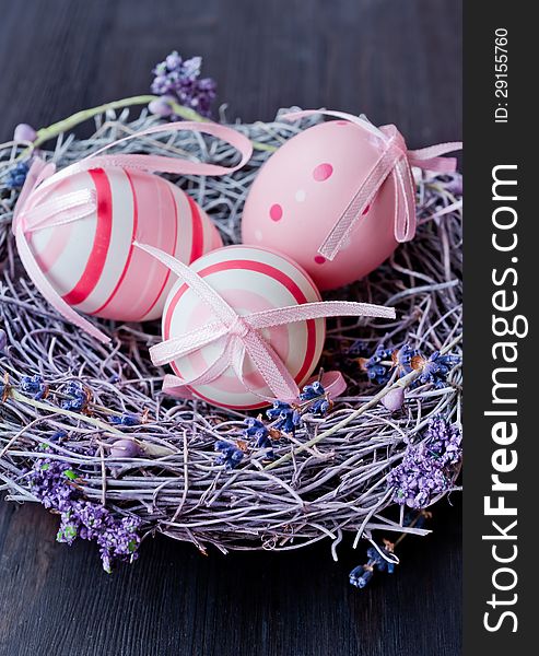 Colorful Easter eggs in a nest with flowers