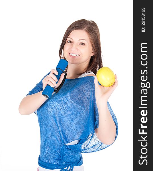 Beautiful young woman with green apple over white background