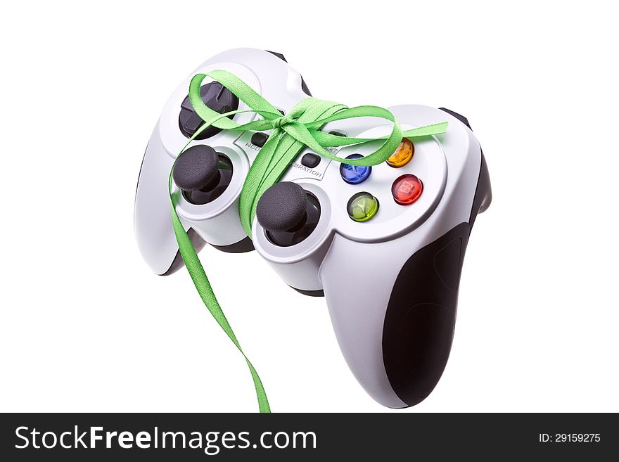 Festive cordless gamepad with a green festive bow. Isolated on white. Festive cordless gamepad with a green festive bow. Isolated on white.