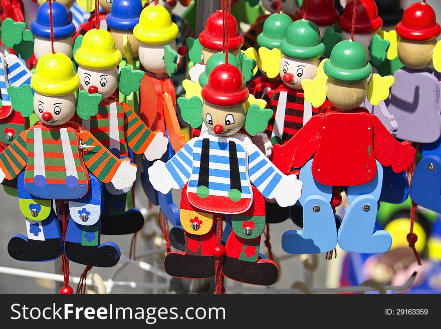 Colorful handmade puppets on display at a street shop