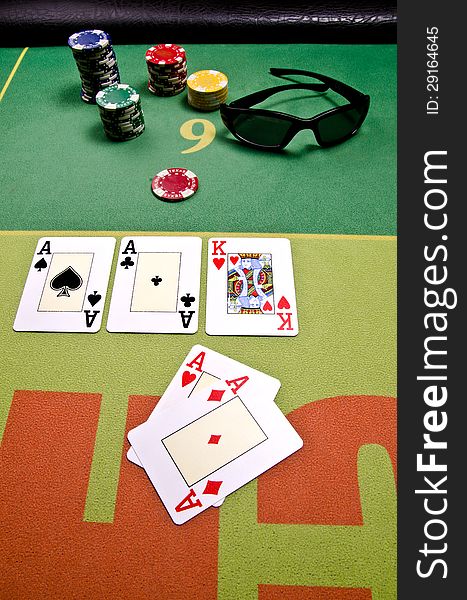 Poker cards and sunglass on the table.