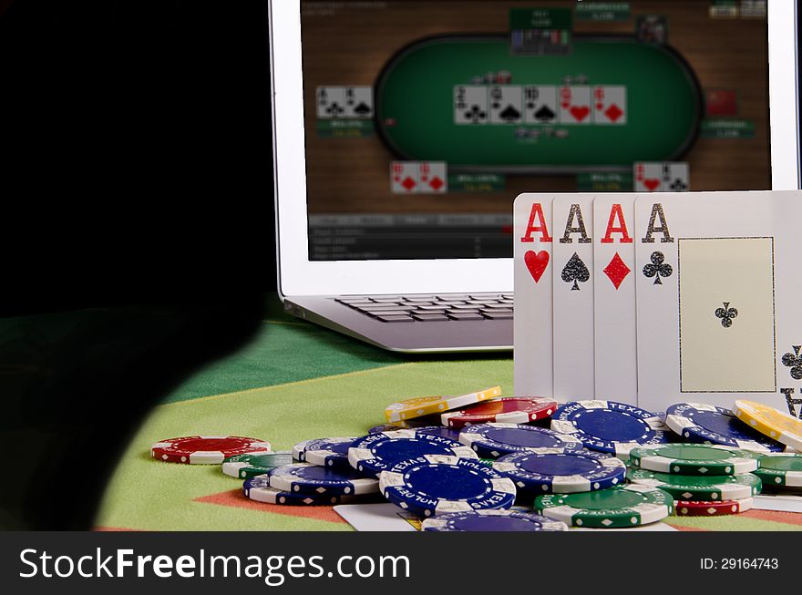 Poker cards and laptop are on the table. Poker cards and laptop are on the table.