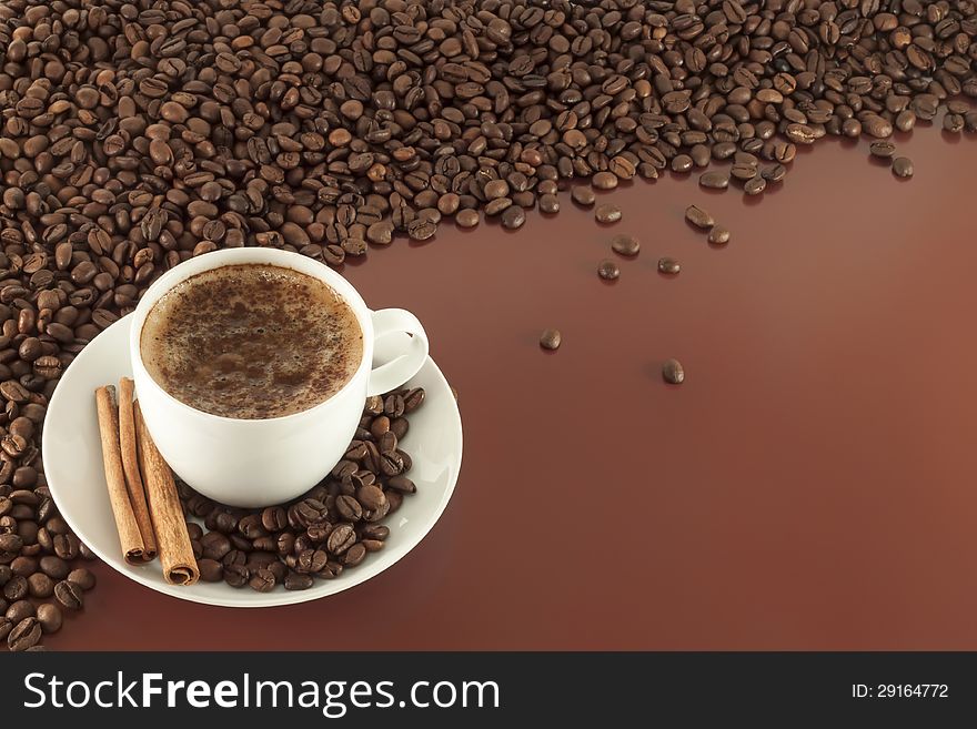 Cup of coffee with cinnamon sticks