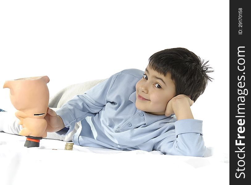 The child smiles the piggy bank is empty. Background brightly lit. The child smiles the piggy bank is empty. Background brightly lit.