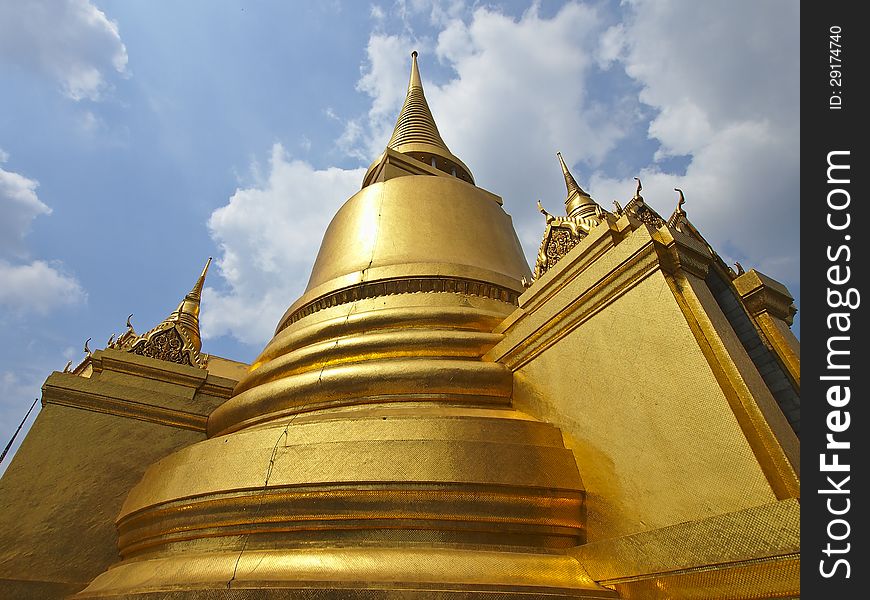 Beautiful golden stupa of grand palace in cloudy day