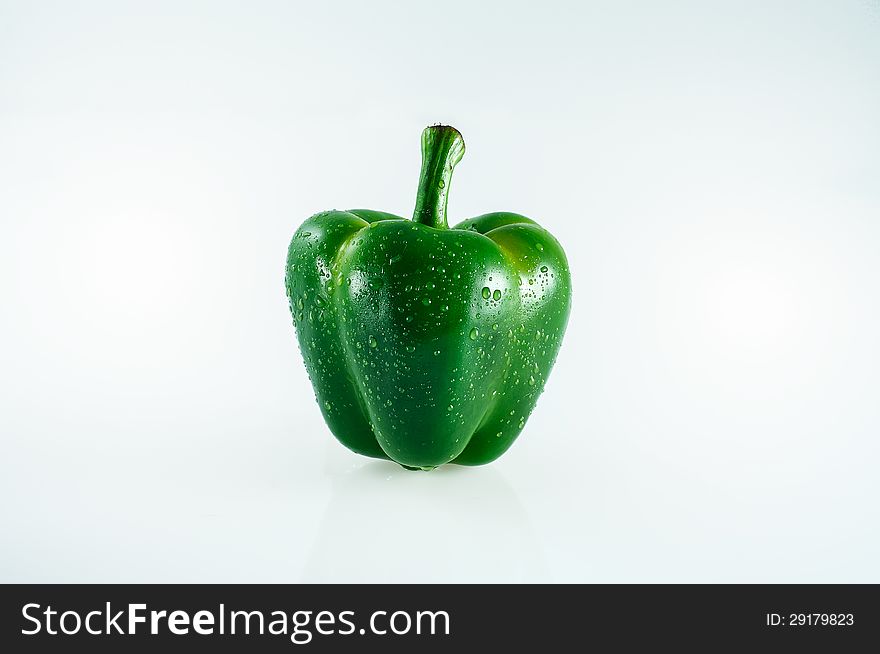 Green pepper with water splash isolated on white background