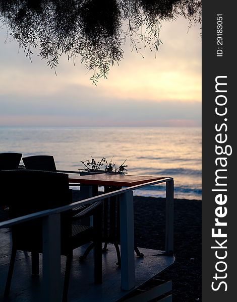 Sunset on the sea, the view through the tables of the restaurant