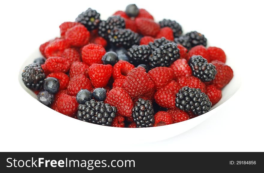 Raspberries, blackberries and blueberries on white background