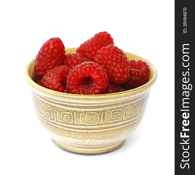 Raspberries in a bowl on white background