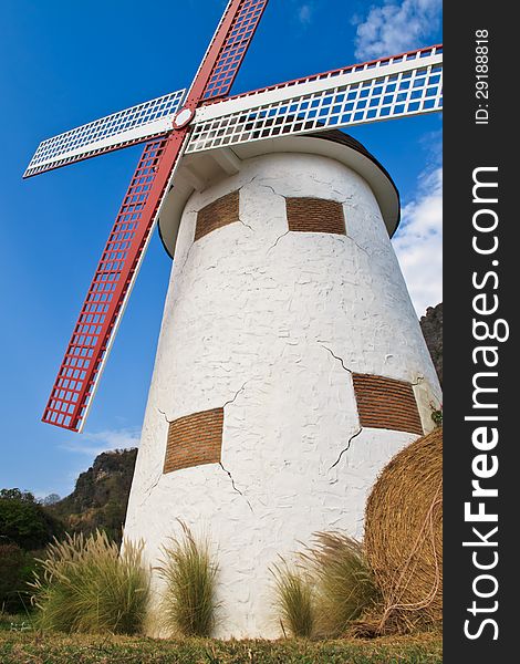 White wind mill with blue sky and cloudy