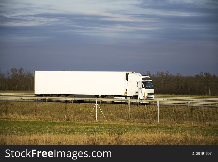 White truck on highway in cloudy weather