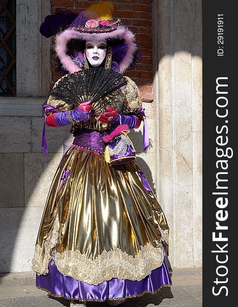 A mask with a black fan in The Carnival of Venice, 2013 edition