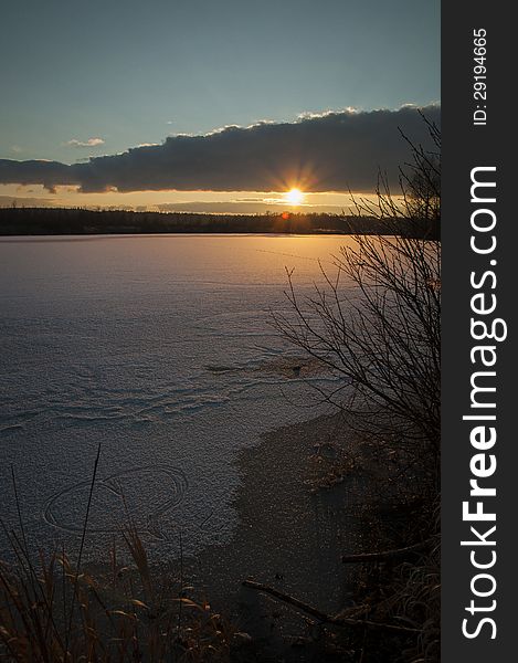 Romantic sunset with a heart written on icy ground.