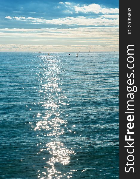 Beautiful sea landscape with boats and sun glare