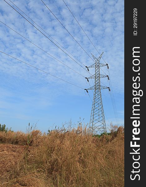 High Voltage power tower line with blue sky in rural area