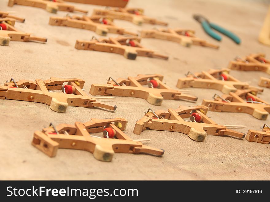 Piano hammers spaced out on a burlap sack being fixed.