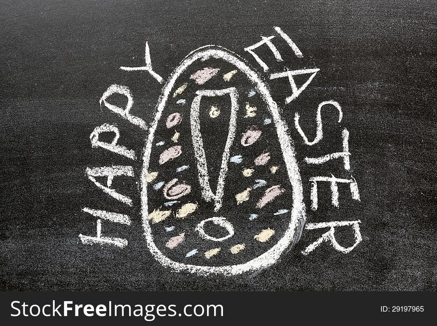 Happy easter phrase handwritten on the school blackboard around painted egg picture with exclamation point
