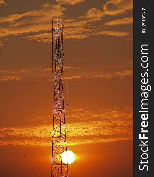 High tower antenna in sunset and red sky. High tower antenna in sunset and red sky
