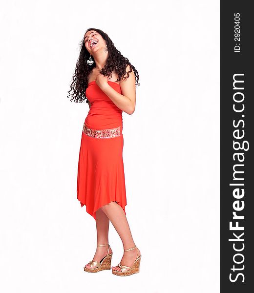 An pretty young girl with long dark hair in an nice red dress is standing
and smiling on white background. An pretty young girl with long dark hair in an nice red dress is standing
and smiling on white background.