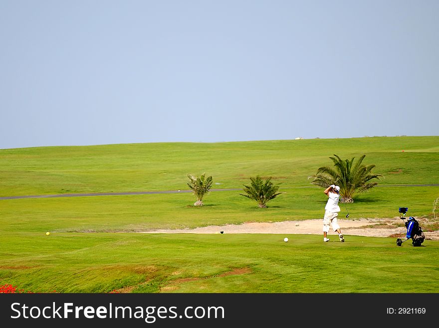 Man playing golf at exotic course