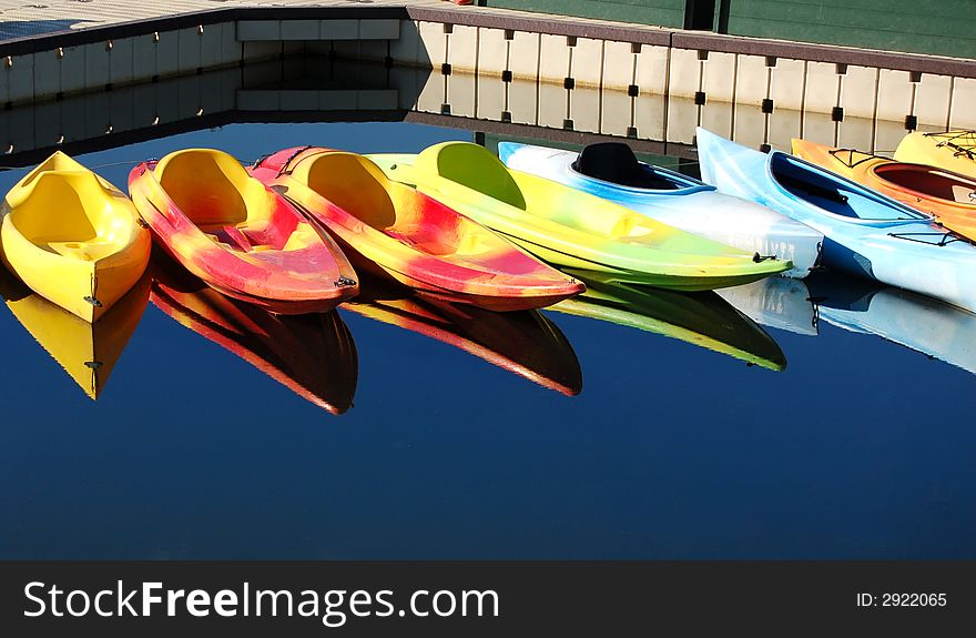 Colorful kayaks reflecting on a river in Oregon. Colorful kayaks reflecting on a river in Oregon