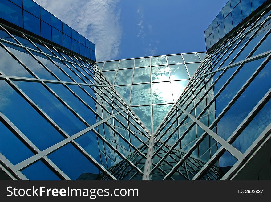 Modern business centre with a sky reflection