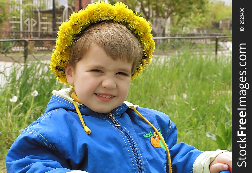 A fun boy with a dandelion garland