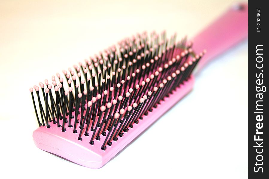 Hair brush of pink color.