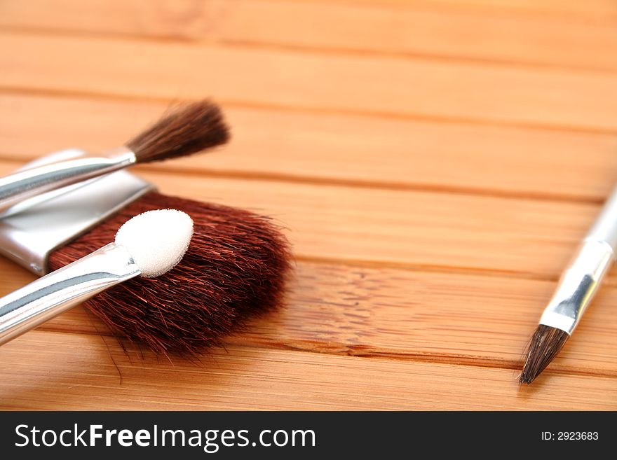 Makeup brushes on wooden carpet 1