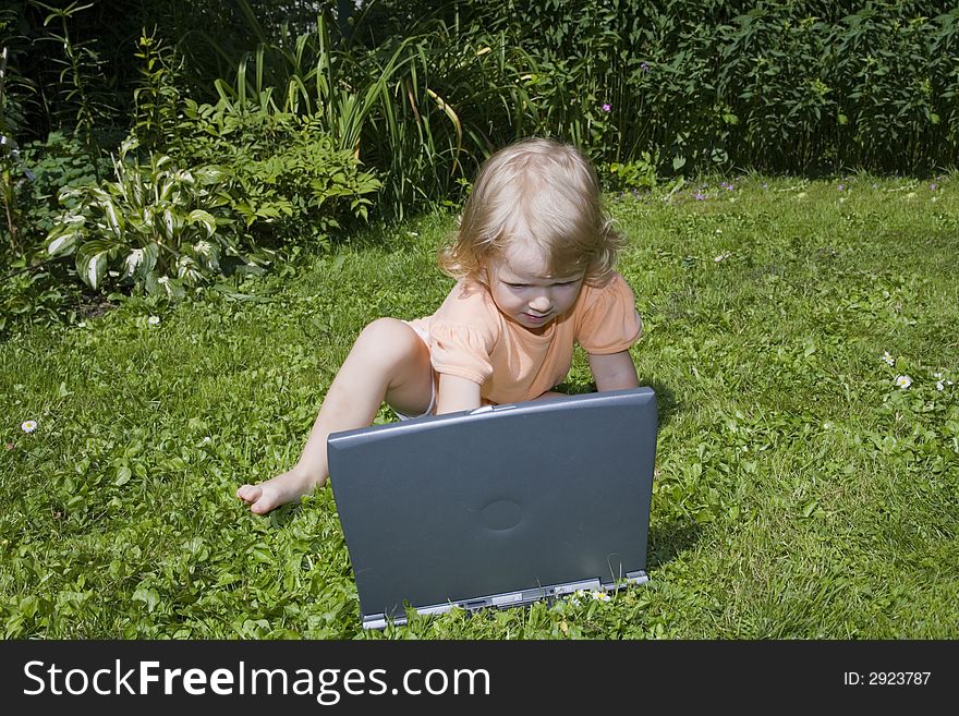 Girl study on computer on lawn