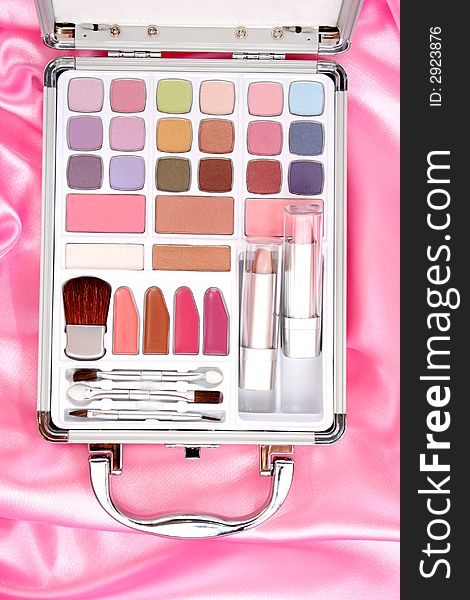 Makeup briefcase on pink satin