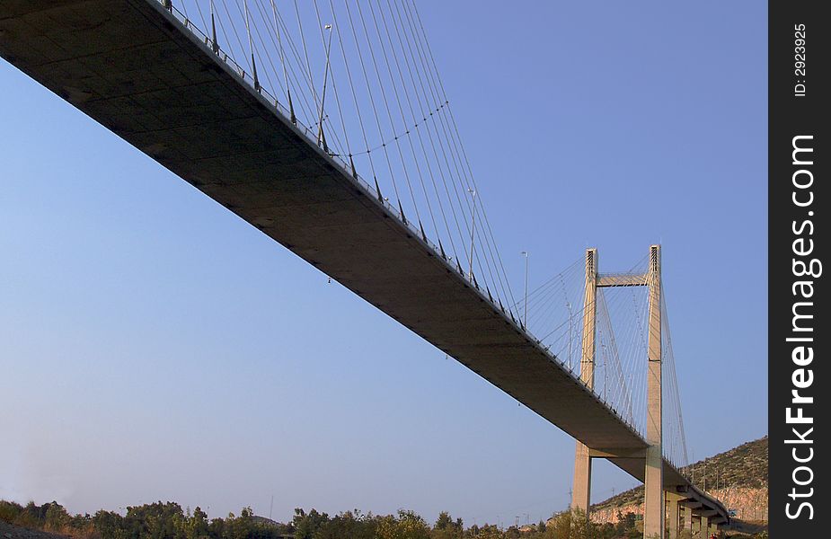 Overhead suspension bridge against dawn sky