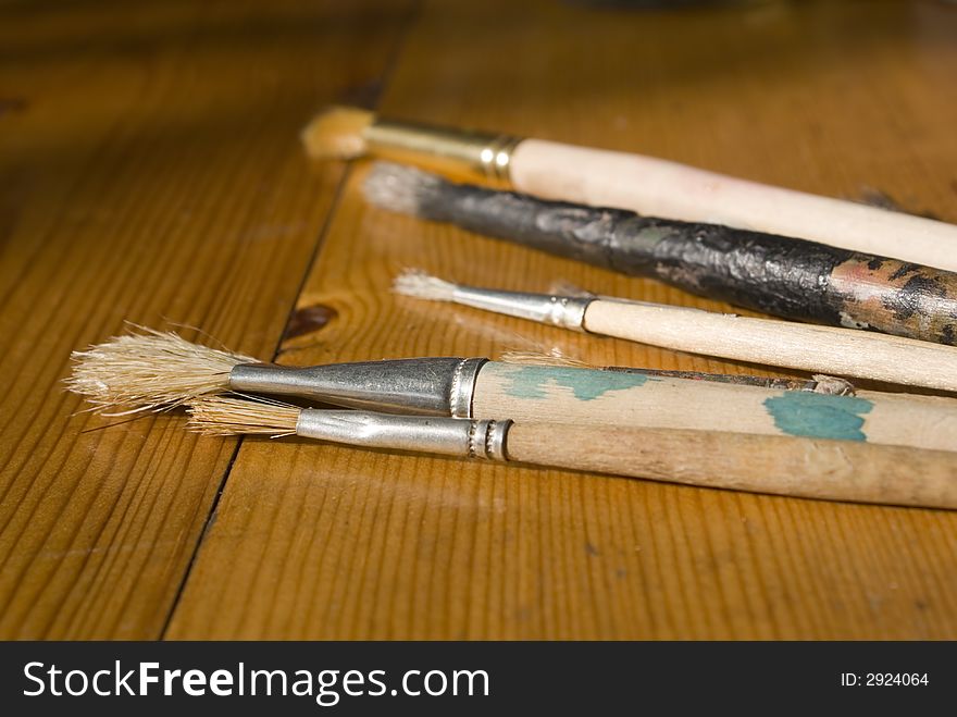 Many used brushes to paint. Low DOF.