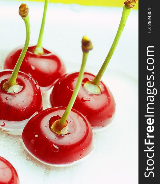 Red cherry laying on a white background