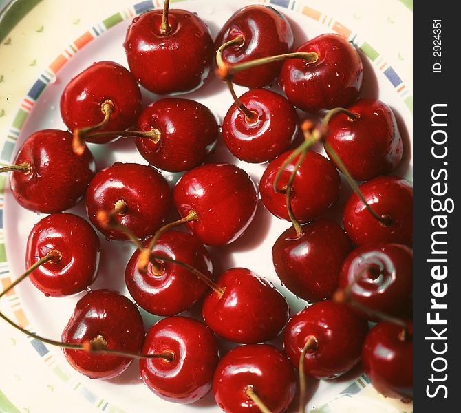 Red cherries costing on a plate. Red cherries costing on a plate