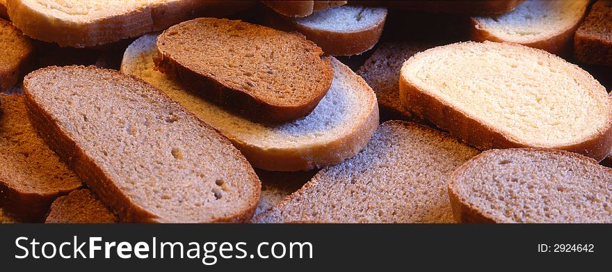 Slices of bread laying on a grey background
