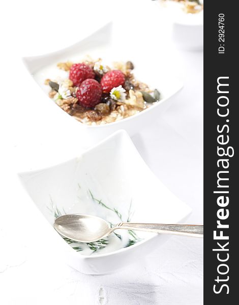 Muesli, cereals, small bowl, raspberries, honey. Muesli, cereals, small bowl, raspberries, honey