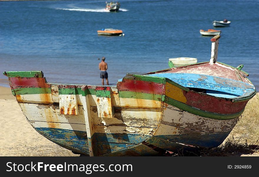 Old boat on the Ferragudo beach, Portugal.