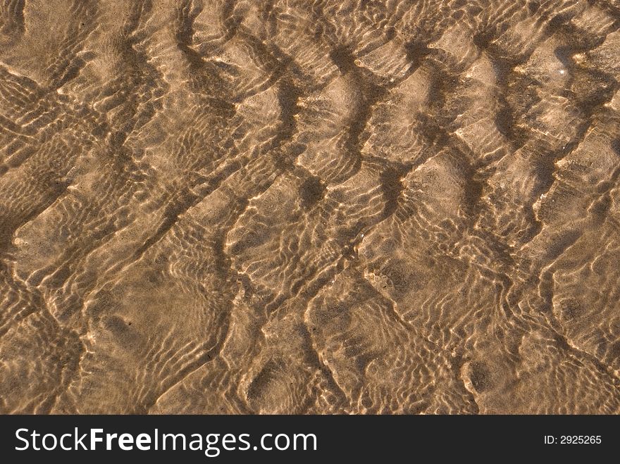 Ripples of light reflecting on river sand. Ripples of light reflecting on river sand