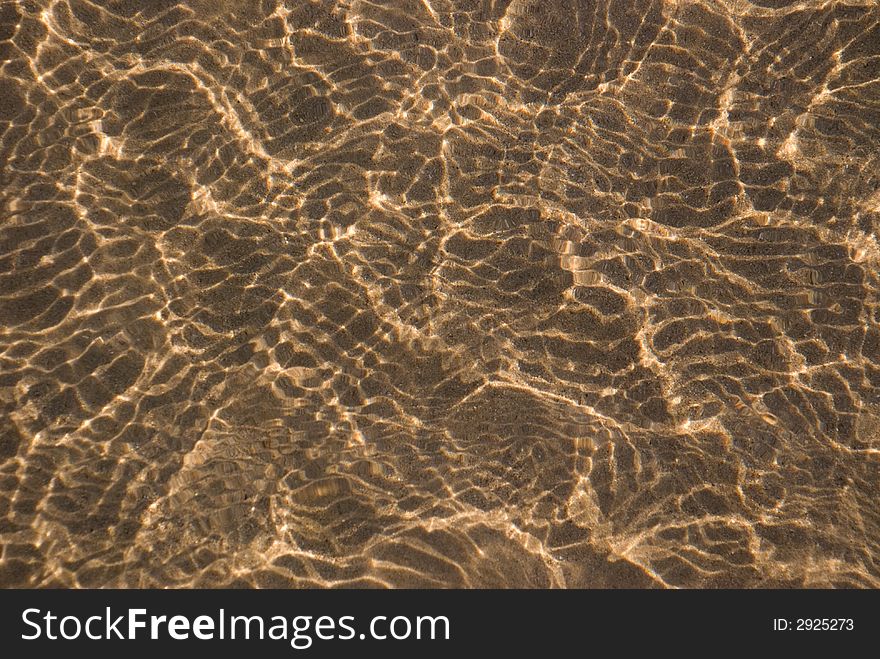 Ripples of light reflecting on river sand. Ripples of light reflecting on river sand