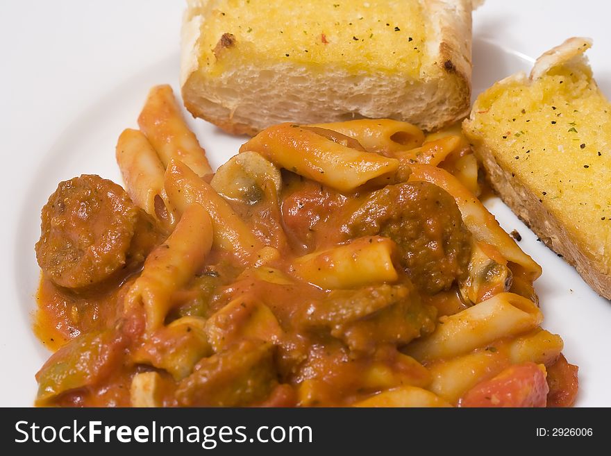 Serving of penne spaghetti white dishes nice reddish colors. Serving of penne spaghetti white dishes nice reddish colors