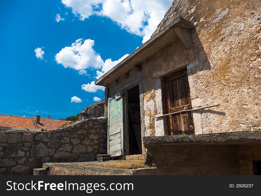 Doorway in to byre, stairs, blue sky with clouds