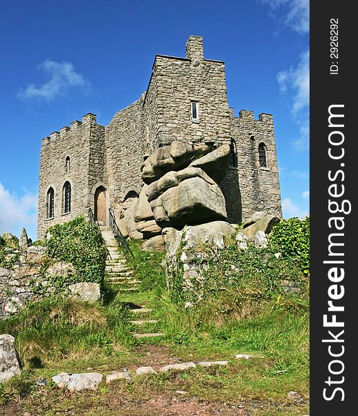 Castle built into rocks against a blue sky