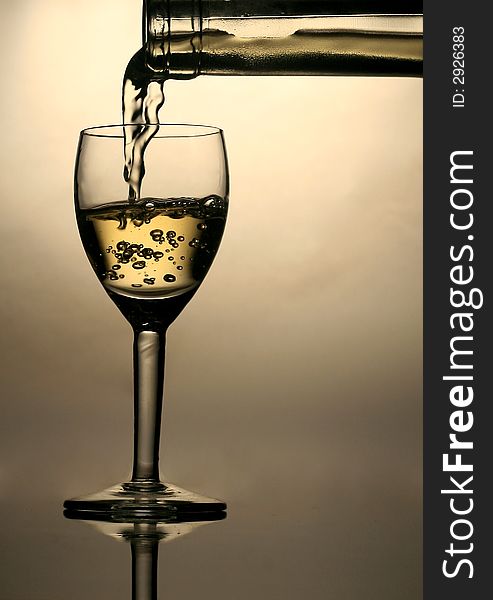 Pouring white wine in glass