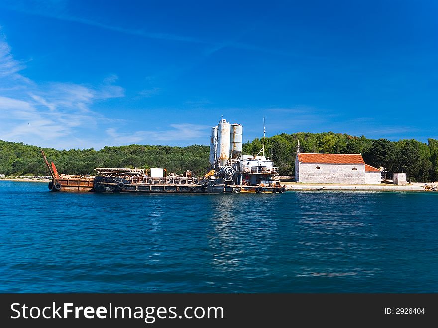 Dirty dock and small church on coast, forst, Croatia. Dirty dock and small church on coast, forst, Croatia