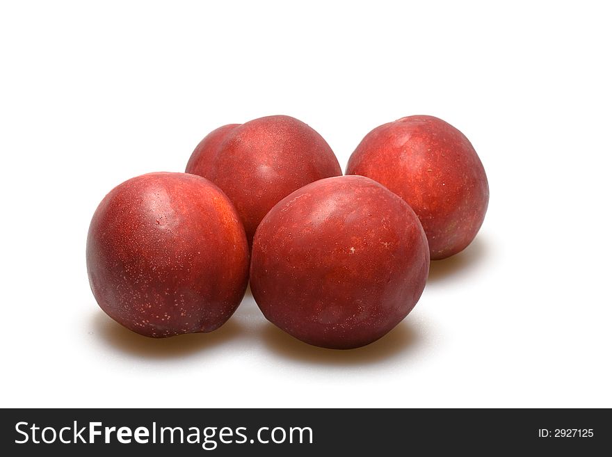 Four nectarine peaches macro on white background. Four nectarine peaches macro on white background