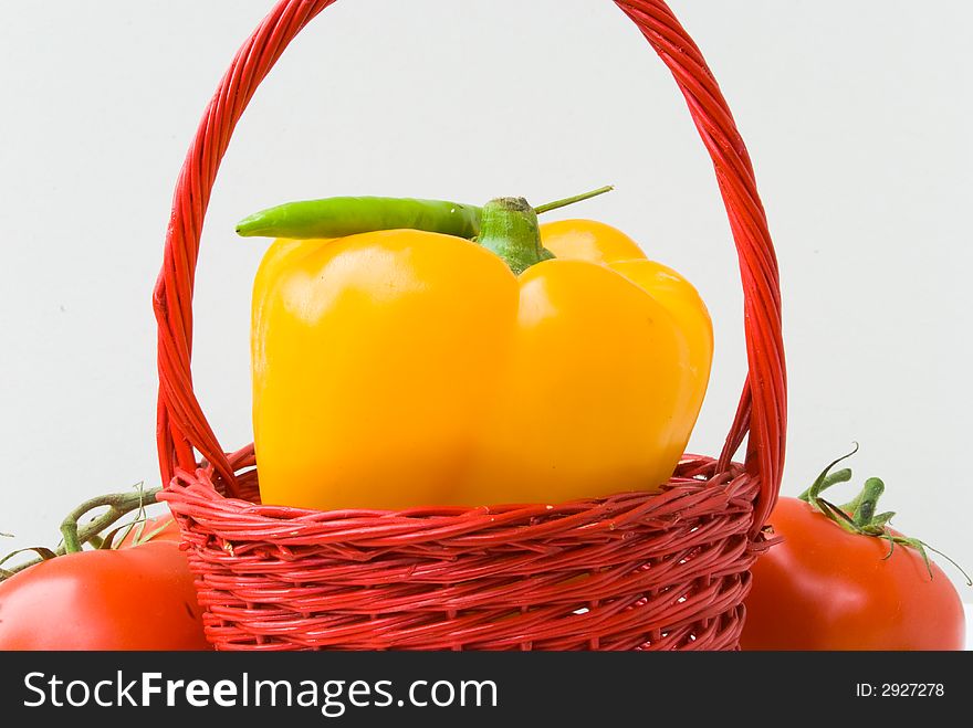 Red basket with yellow pepper.