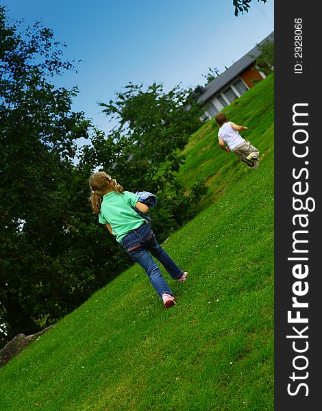 Girl and boy running across green lawn. Girl and boy running across green lawn